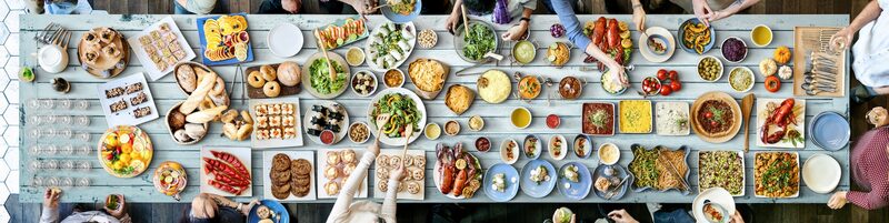 A catering table laid with dishes for a memorial gathering
