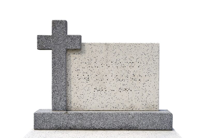 A granite headstone with a carved cross, ready for inscription
